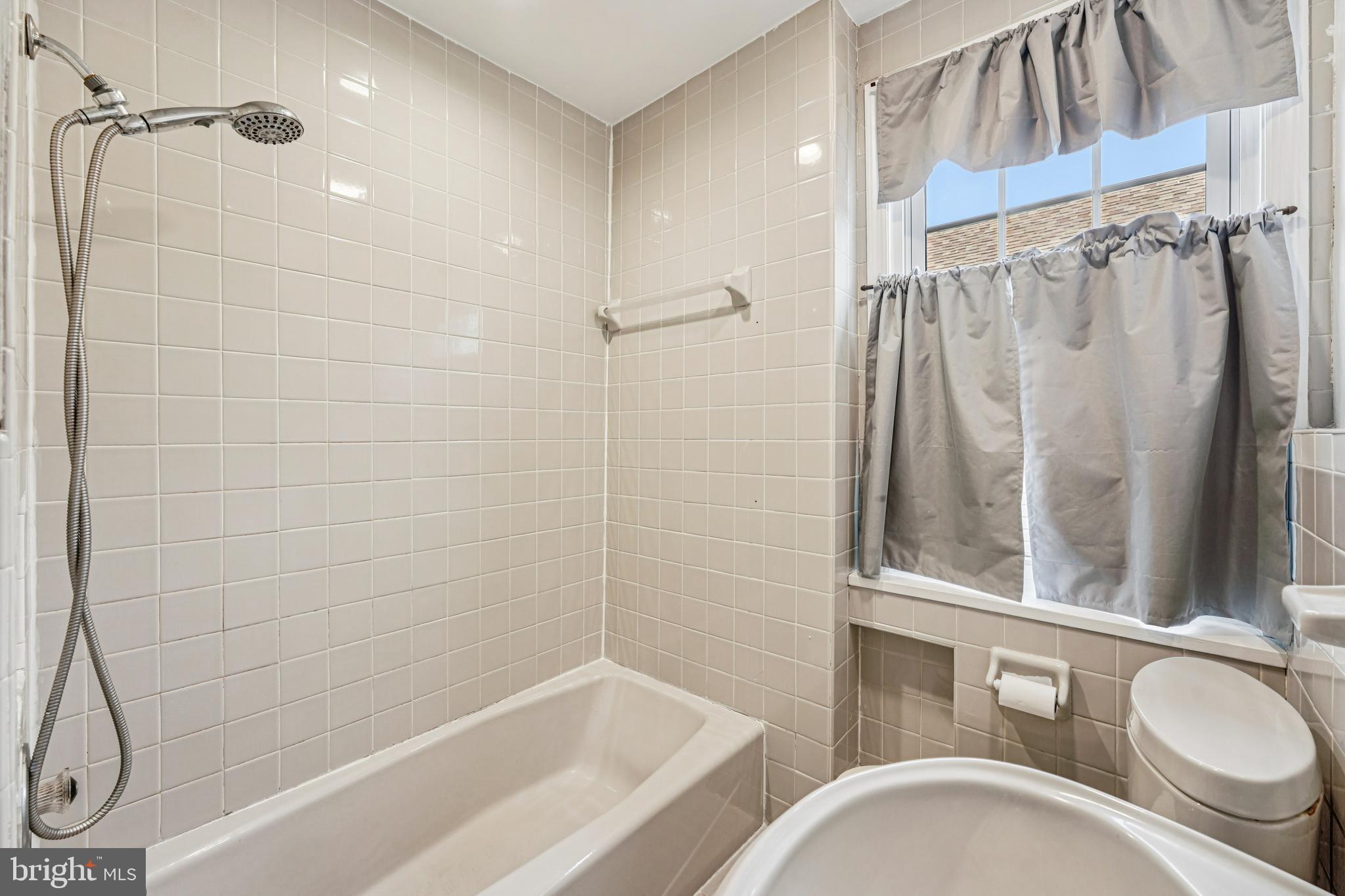 19 Wayne Avenue Springfield, PA 19064 - Photo 23 of 56 a bathroom with a granite countertop bathtub shower sink vanity and toilet