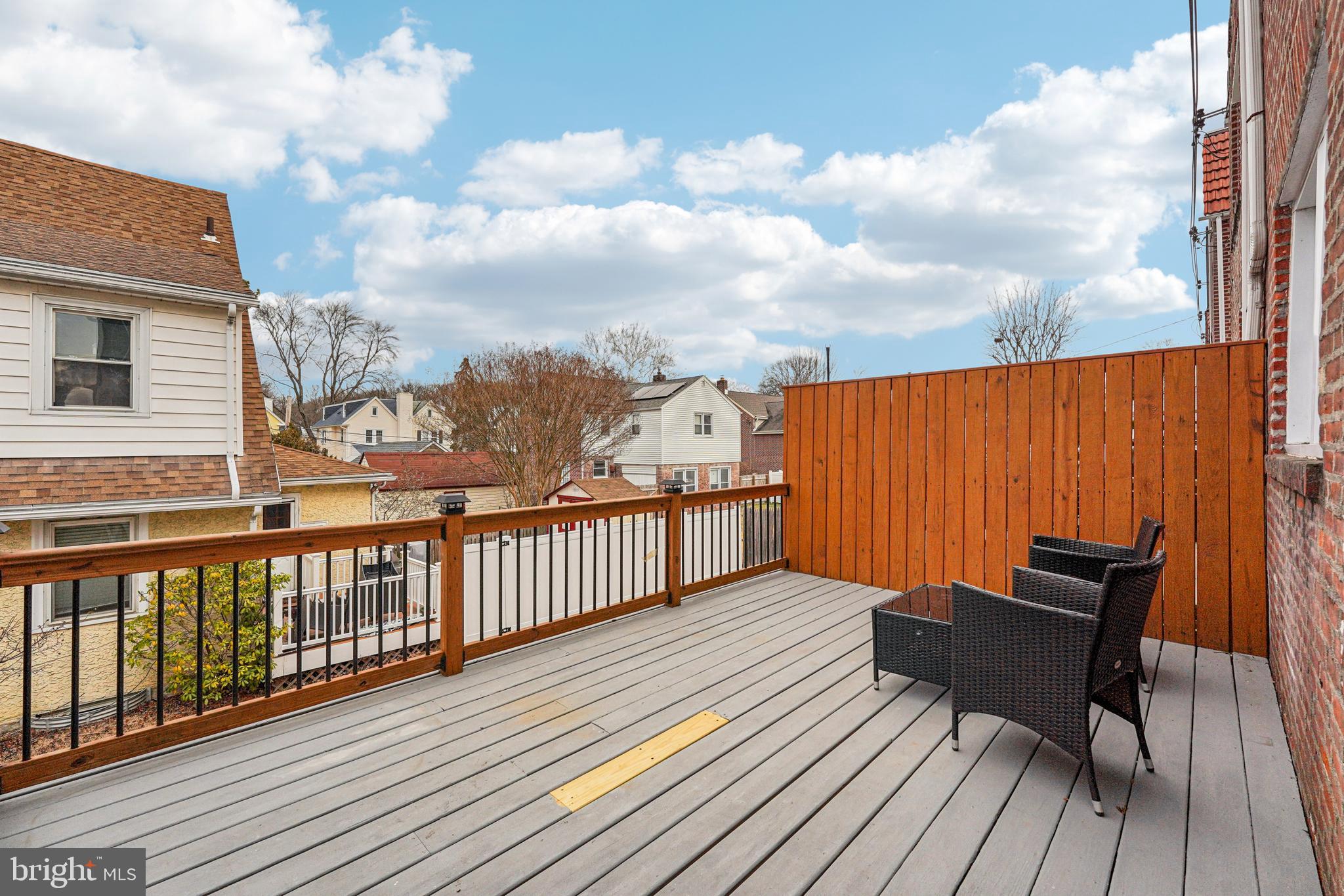 19 Wayne Avenue Springfield, PA 19064 - Photo 41 of 56 a balcony with wooden floor table and chairs