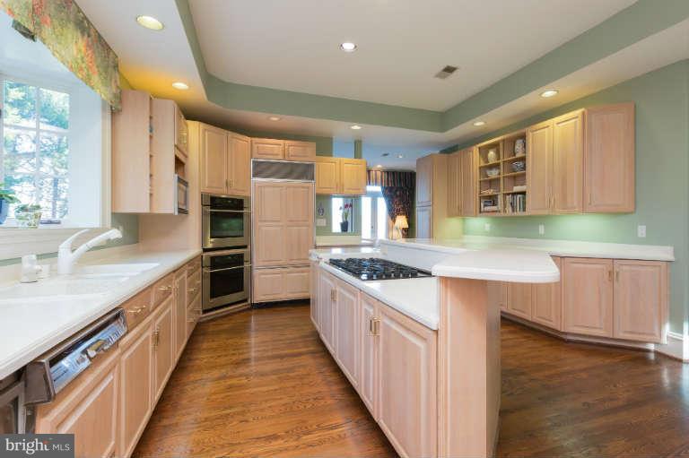 626 Chain Bridge Road McLean, VA 22101 - Photo 15 of 30 a kitchen with stainless steel appliances granite countertop wooden cabinets sink and stove