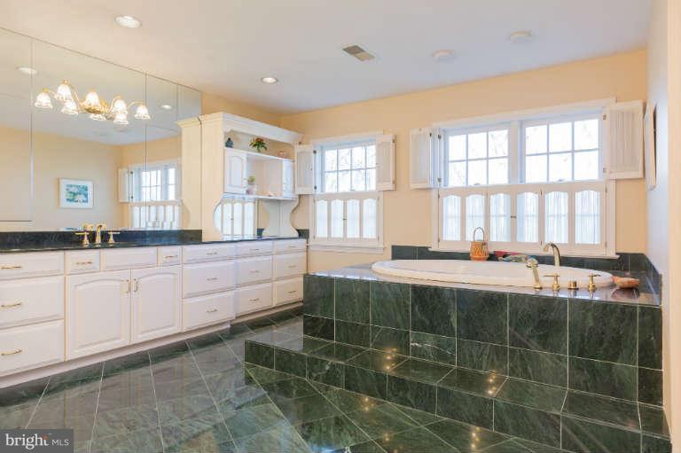 626 Chain Bridge Road McLean, VA 22101 - Photo 17 of 30 a spacious bathroom with a tub a double vanity sink and a mirror