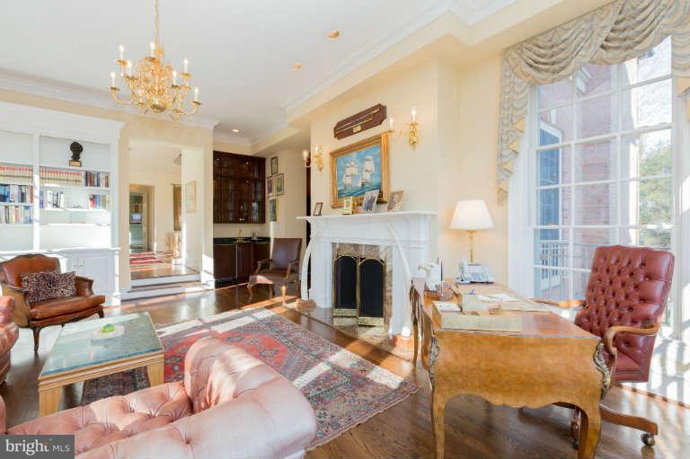 626 Chain Bridge Road McLean, VA 22101 - Photo 7 of 30 a living room with furniture a fireplace and a chandelier