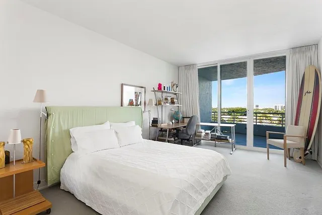 a view of a backyard with plants and palm trees