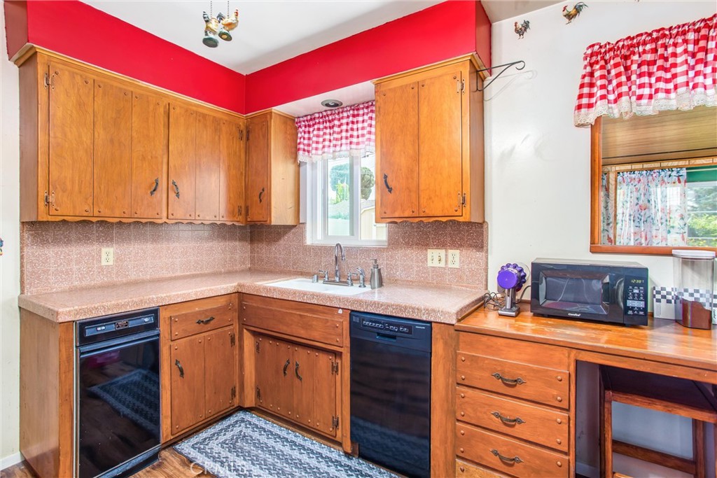 217 Syllmar Circle Calimesa, CA 92320 - Photo 12 of 28 a kitchen with a sink cabinets and window