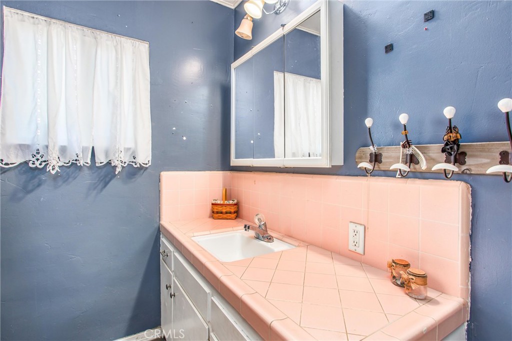 217 Syllmar Circle Calimesa, CA 92320 - Photo 15 of 28 a bathroom with a sink and a mirror