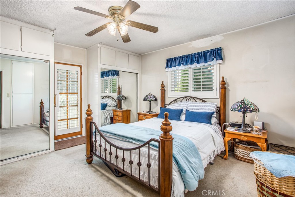 217 Syllmar Circle Calimesa, CA 92320 - Photo 17 of 28 a bedroom with a bed and a chandelier