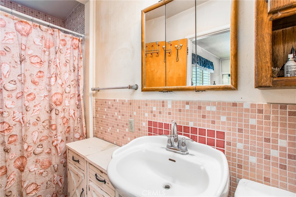 217 Syllmar Circle Calimesa, CA 92320 - Photo 20 of 28 a bathroom with a sink and a mirror