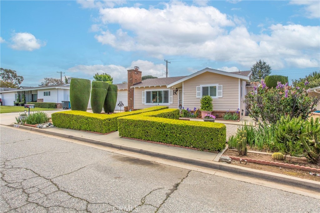 217 Syllmar Circle Calimesa, CA 92320 - Photo 4 of 28 a front view of a house with a garden and plants