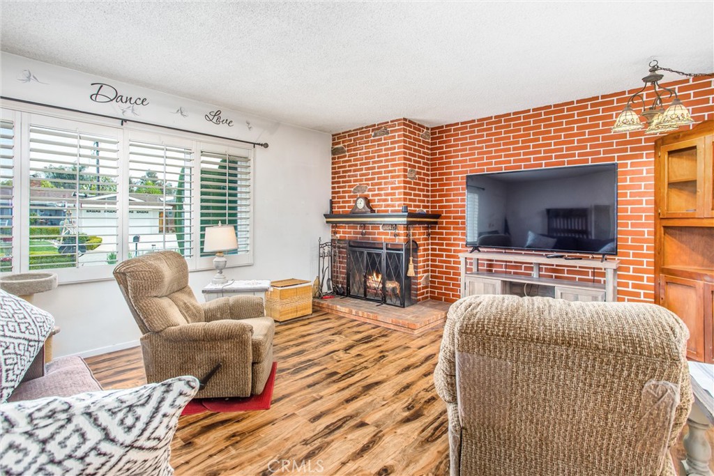 217 Syllmar Circle Calimesa, CA 92320 - Photo 6 of 28 a living room with fireplace furniture and a flat screen tv