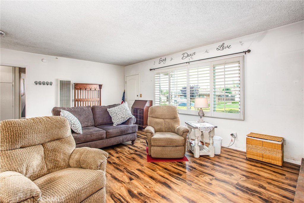 217 Syllmar Circle Calimesa, CA 92320 - Photo 7 of 28 a living room with furniture and a window
