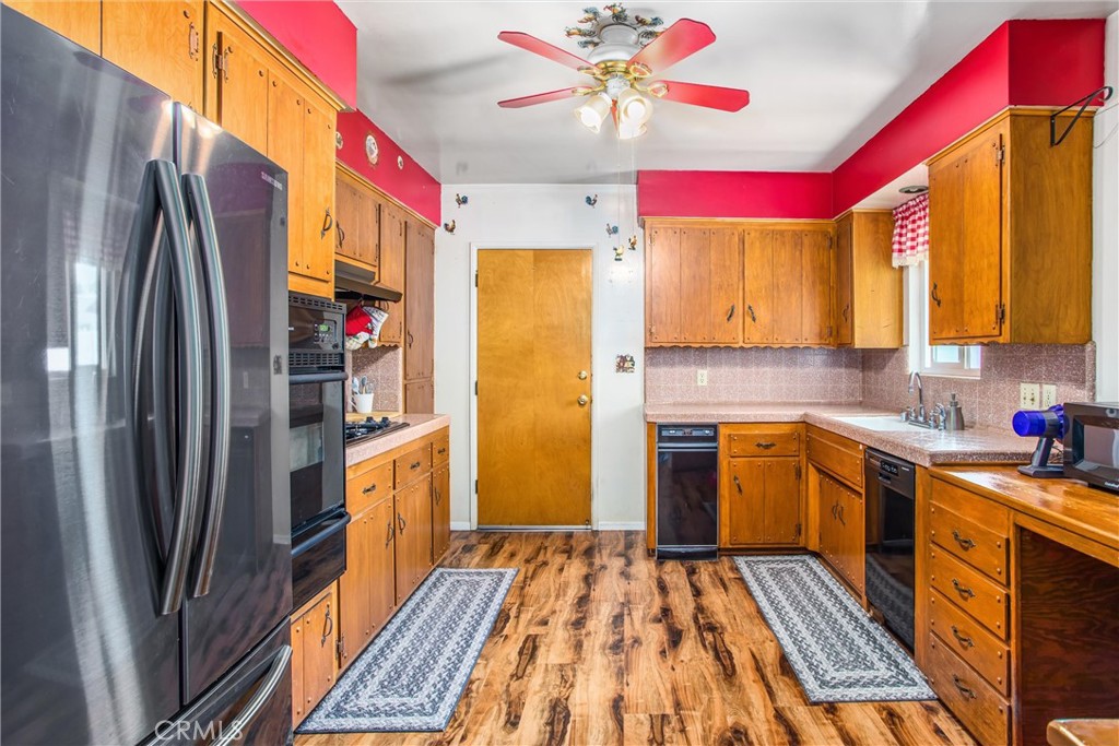 217 Syllmar Circle Calimesa, CA 92320 - Photo 10 of 28 a kitchen with stainless steel appliances granite countertop a refrigerator and a stove