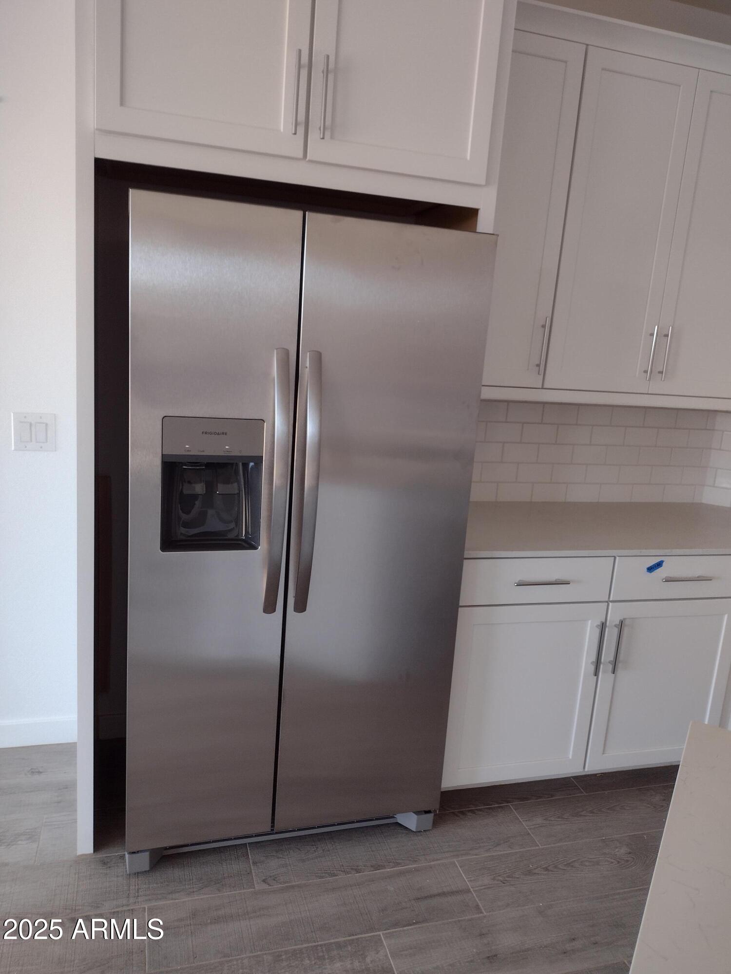 1536 West Corral Road Phoenix, AZ 85041 - Photo 4 of 16 a kitchen with a refrigerator and cabinets