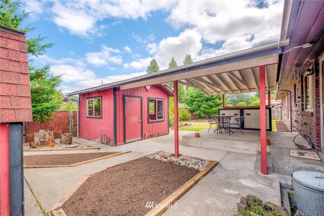 a front view of a house with outdoor space and sitting area