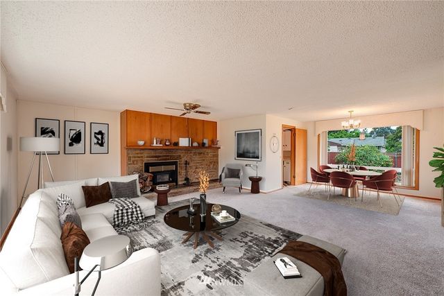 a living room with furniture a large window and a flat screen tv