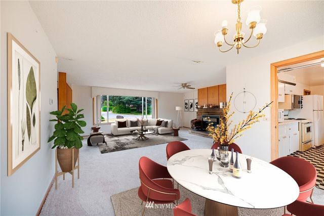 a living room with fireplace furniture and a large window