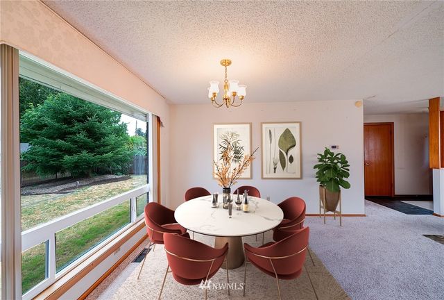 a view of a dining room with furniture window and outside view