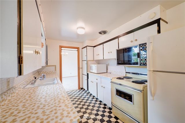 a kitchen with stainless steel appliances a refrigerator stove and sink