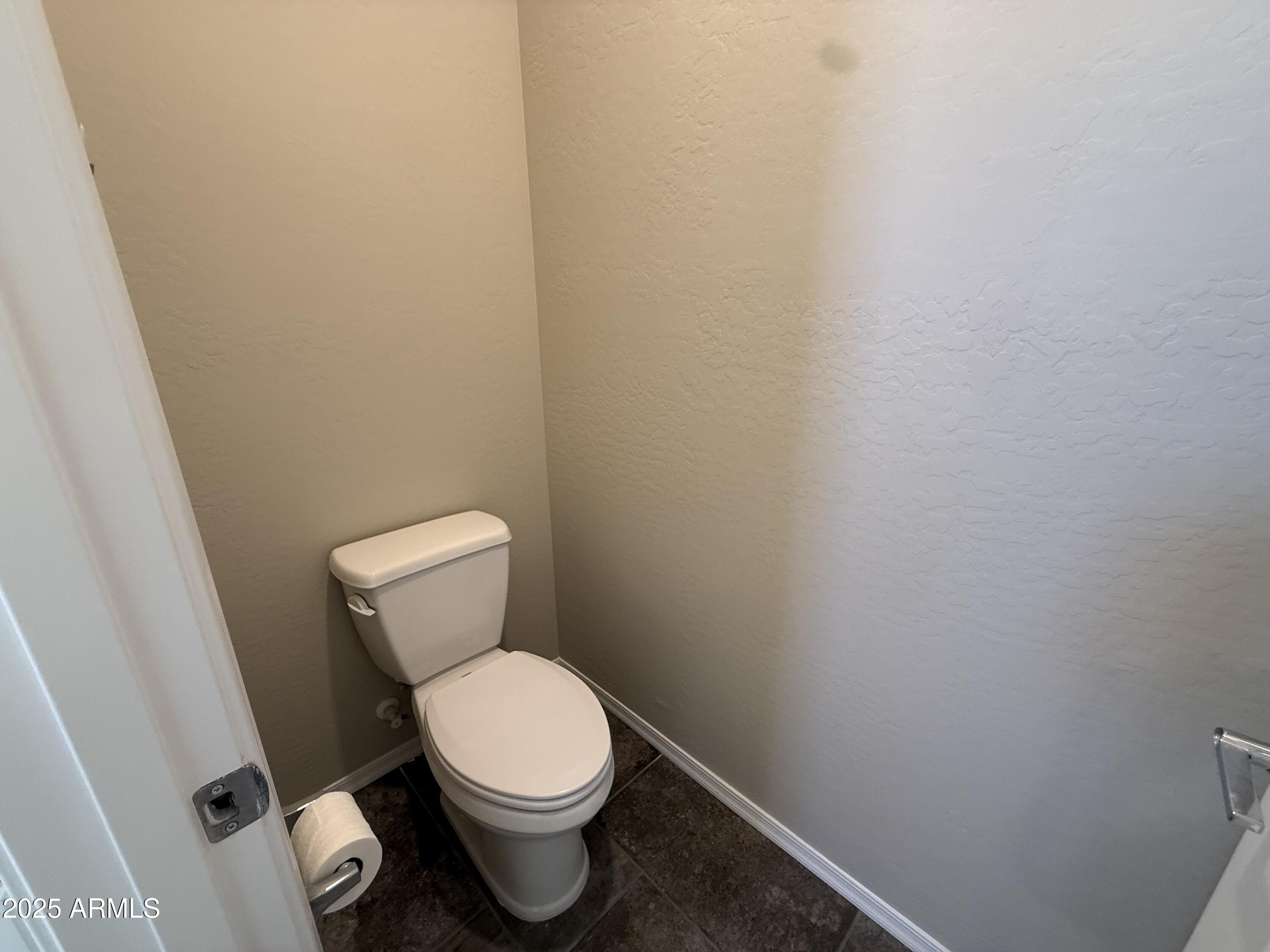 1959 East Hampton Lane, Unit 101 Gilbert, AZ 85295 - Photo 11 of 23 a white toilet sitting next to a white wall