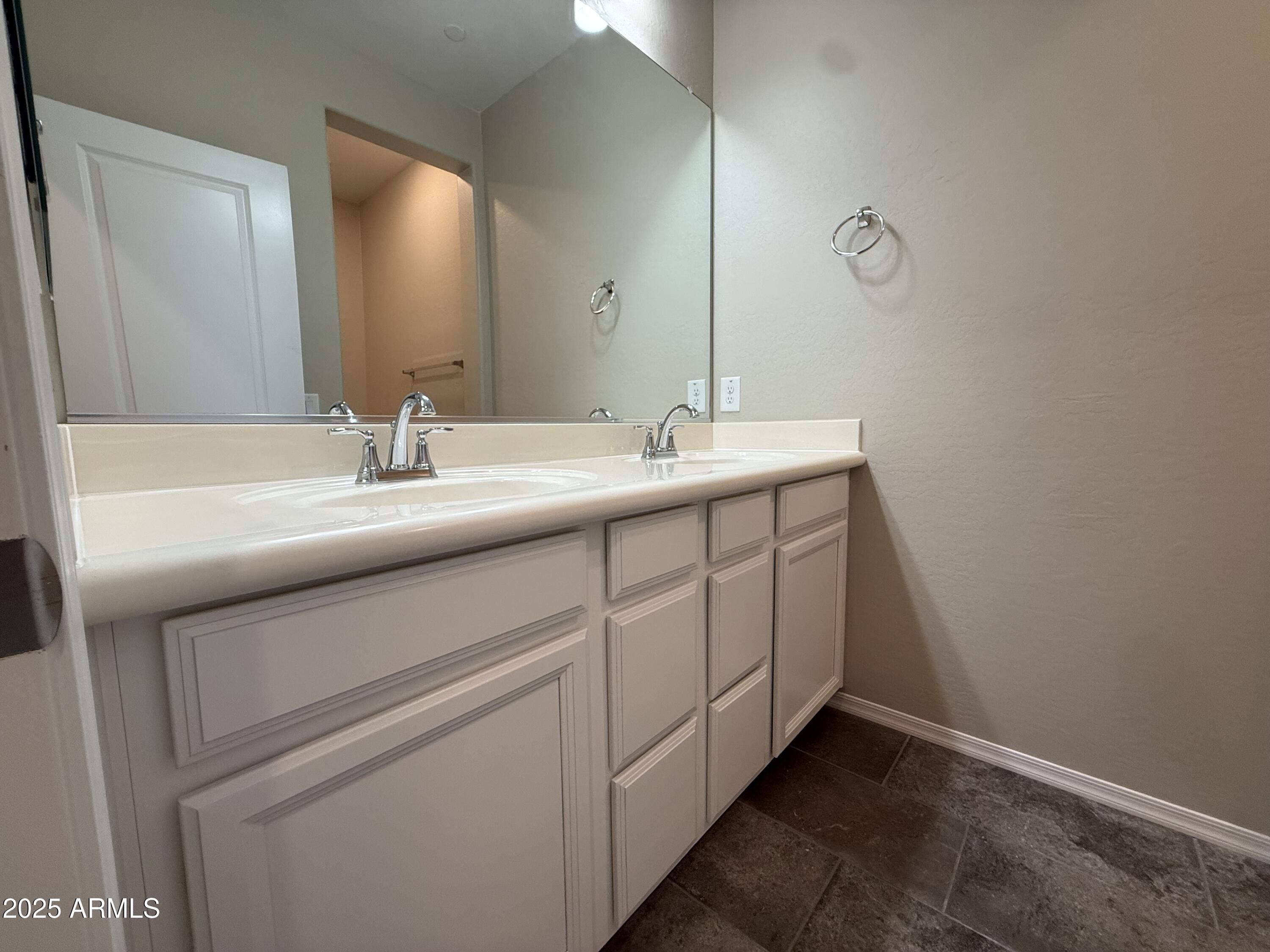 1959 East Hampton Lane, Unit 101 Gilbert, AZ 85295 - Photo 16 of 23 a bathroom with a double vanity sink and a mirror