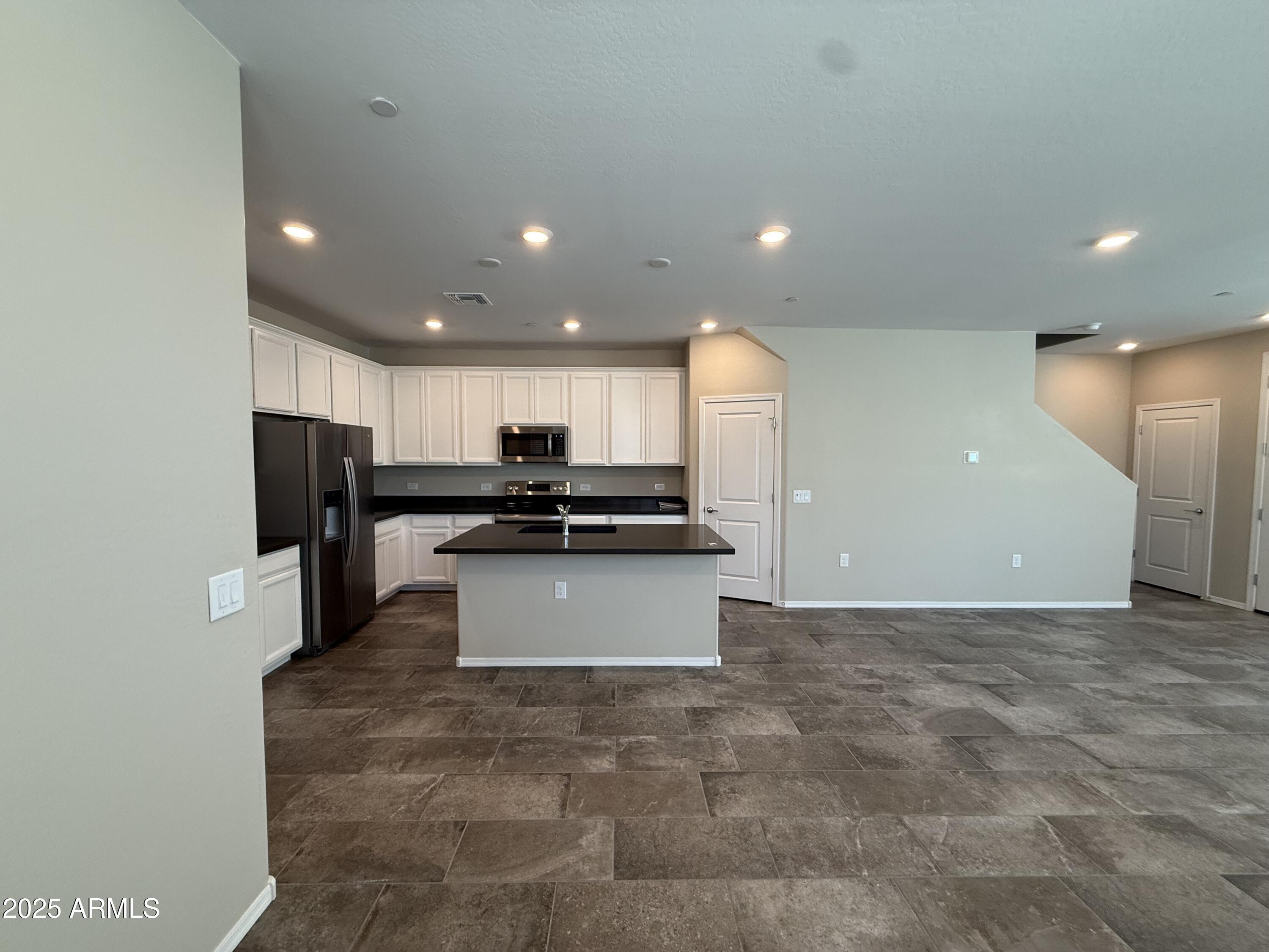1959 East Hampton Lane, Unit 101 Gilbert, AZ 85295 - Photo 4 of 23 a large kitchen with stainless steel appliances a large counter top