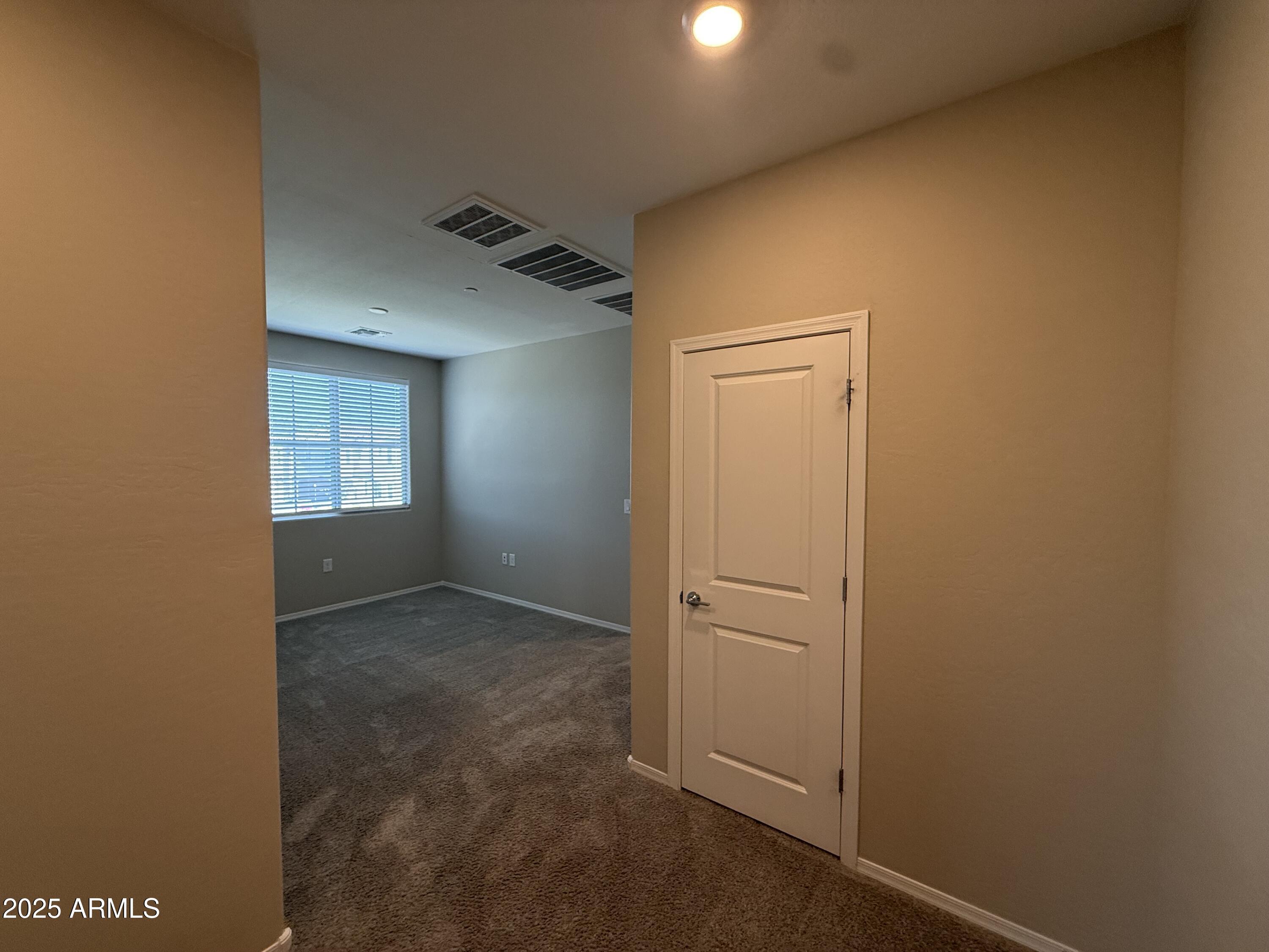 1959 East Hampton Lane, Unit 101 Gilbert, AZ 85295 - Photo 7 of 23 an empty room with windows