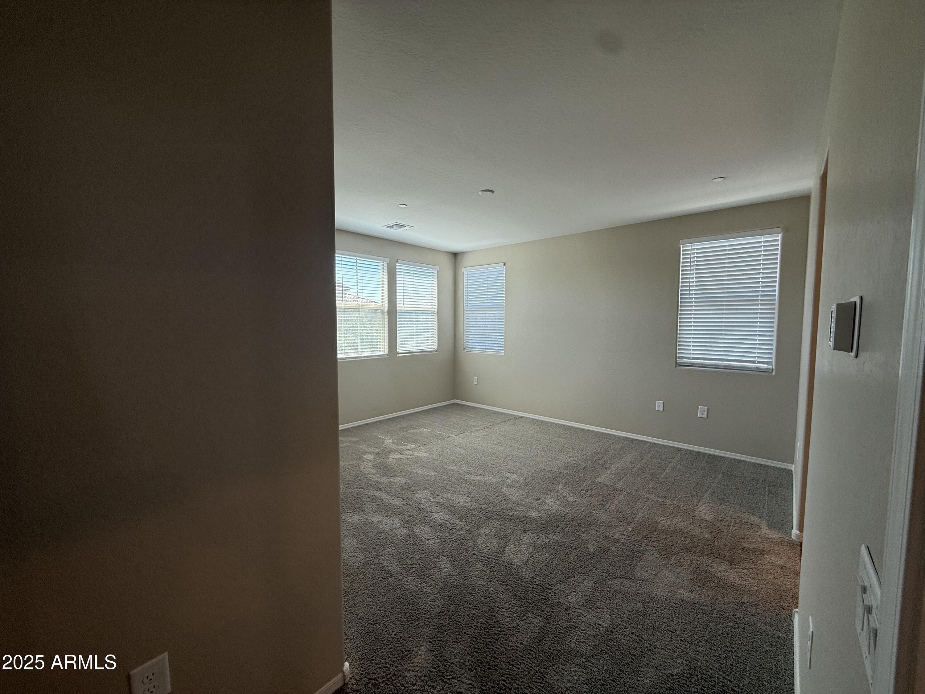 1959 East Hampton Lane, Unit 101 Gilbert, AZ 85295 - Photo 8 of 23 an empty room with windows