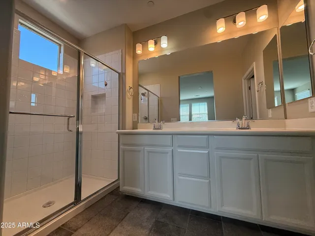 a bathroom with a double vanity sink and a mirror