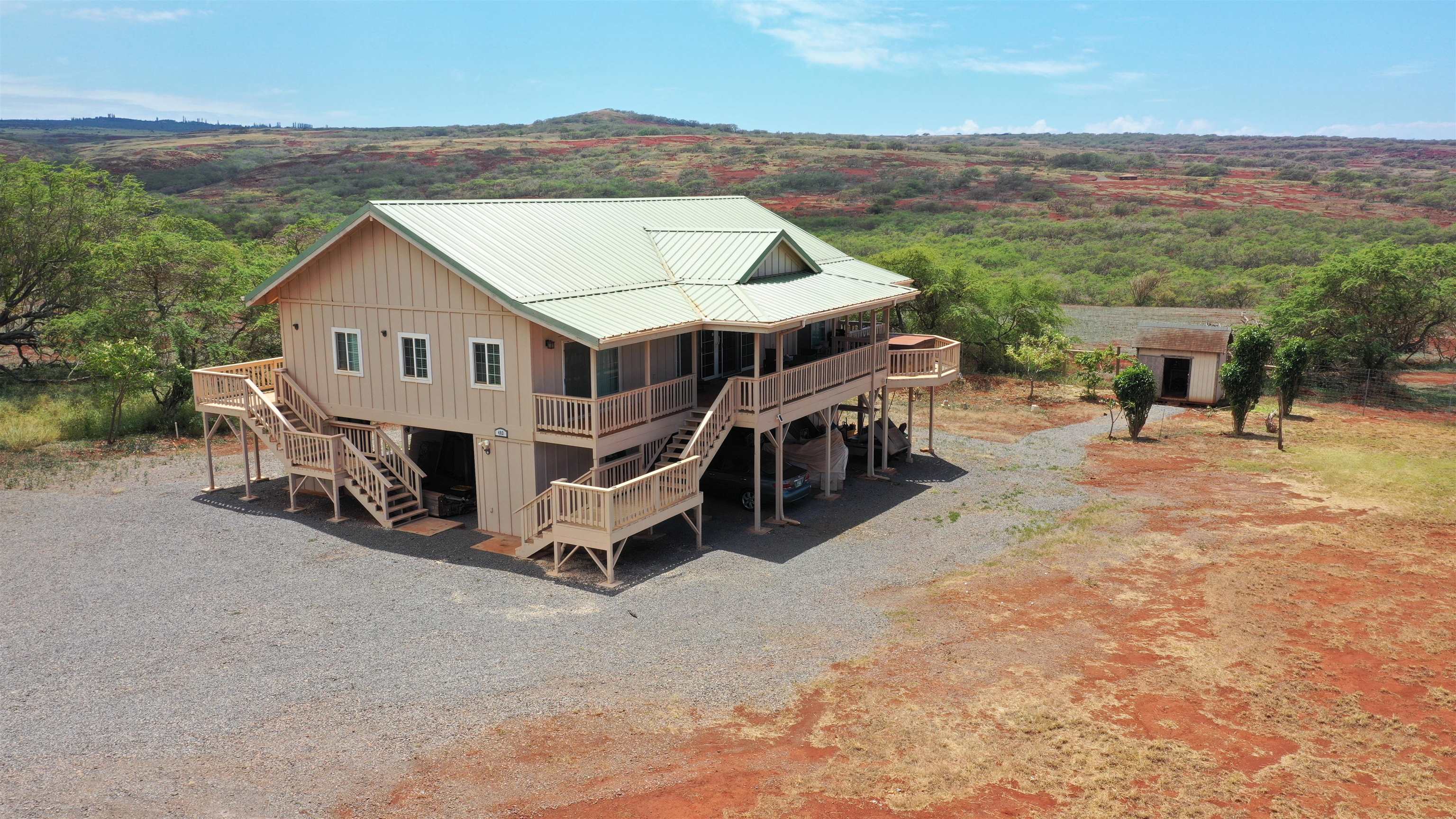 a view of a house with a yard and sitting area