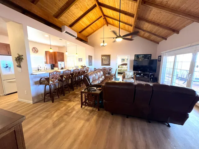 a living room with lots of furniture and wooden floor