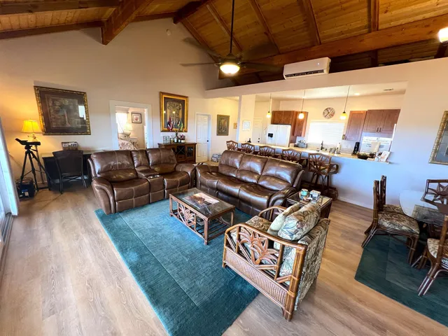 a large kitchen with a sink a counter top space a refrigerator and a sink