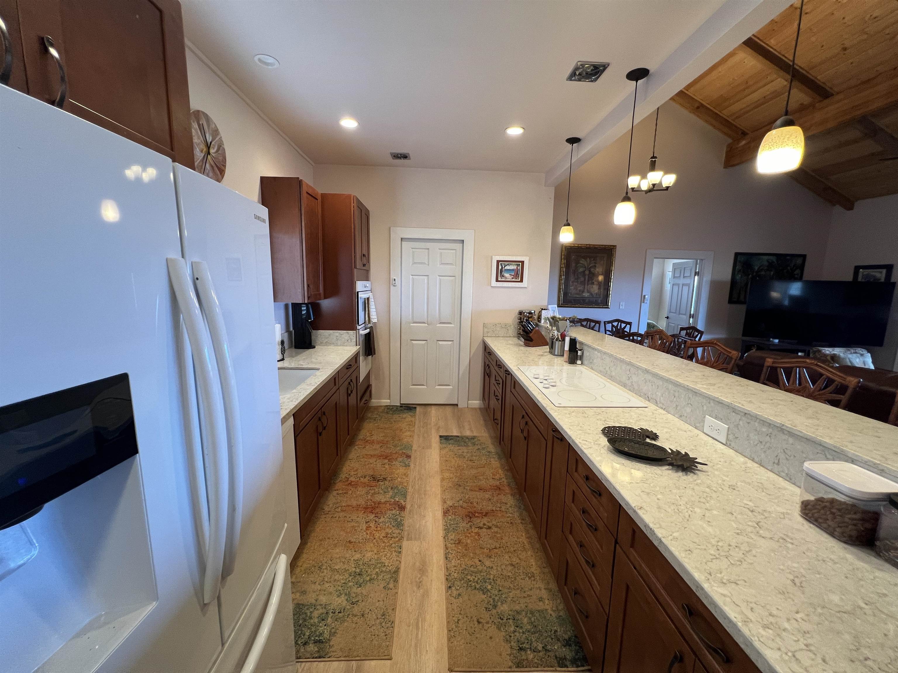 403 Pa Loa Loop, Unit LOT #221 Maunaloa, HI 96770 - Photo 16 of 33 a large kitchen with a sink a counter top space a refrigerator and a sink