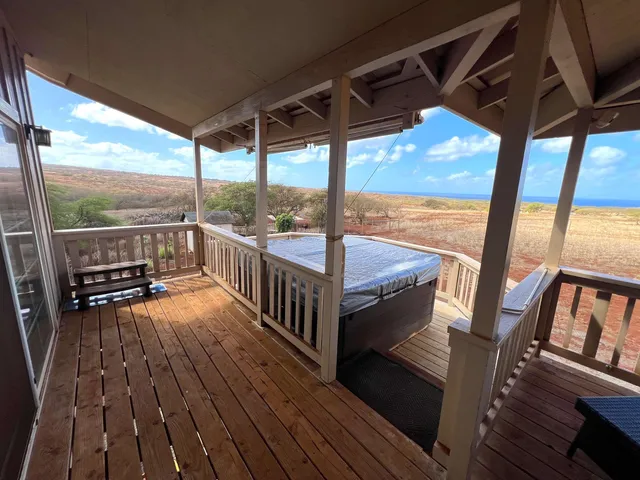 a view of a balcony with wooden floor