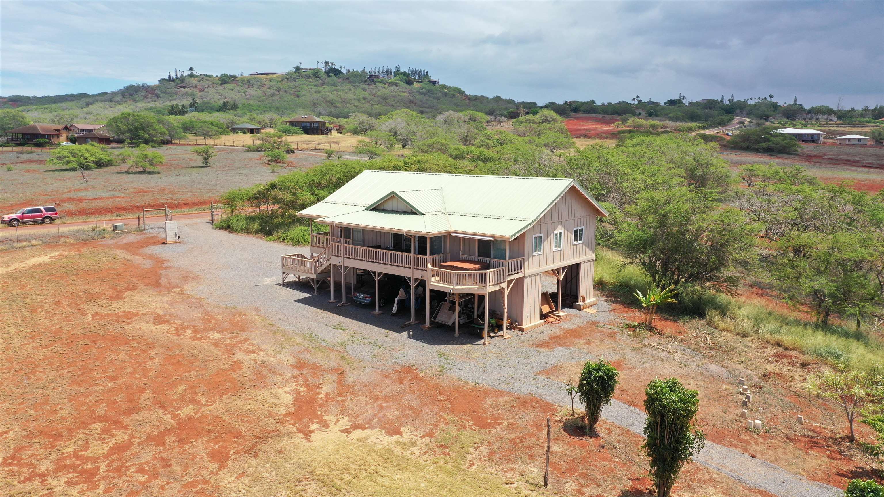 403 Pa Loa Loop, Unit LOT #221 Maunaloa, HI 96770 - Photo 8 of 33 an aerial view of a house with big yard and large trees