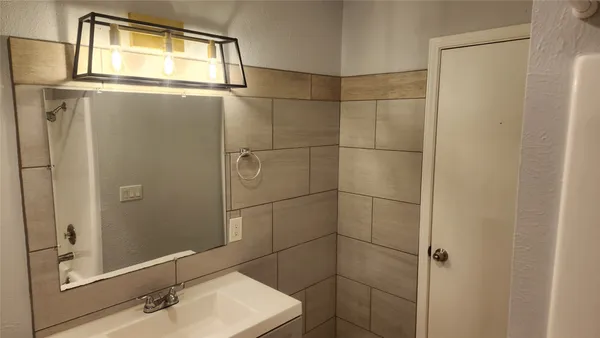 a bathroom with a shower and a sink