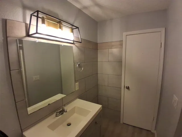 a bathroom with a sink a mirror and shower