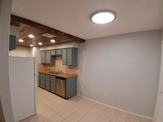 a kitchen with stainless steel appliances granite countertop a sink and a wooden cabinets