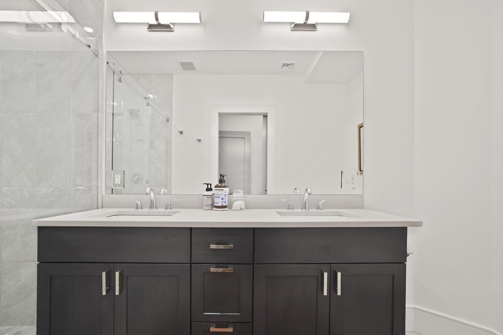 49 Boylston Street Boston, MA 02130 - Photo 15 of 36 a bathroom with a double vanity sink and a mirror