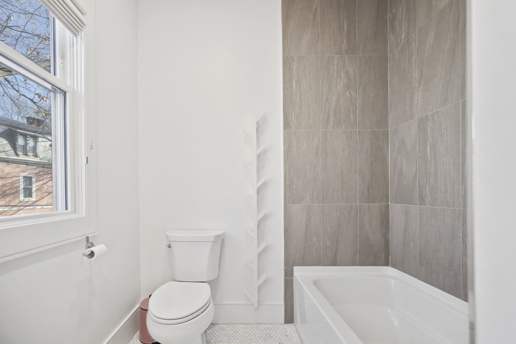 49 Boylston Street Boston, MA 02130 - Photo 21 of 36 a bathroom with a toilet and a bathtub