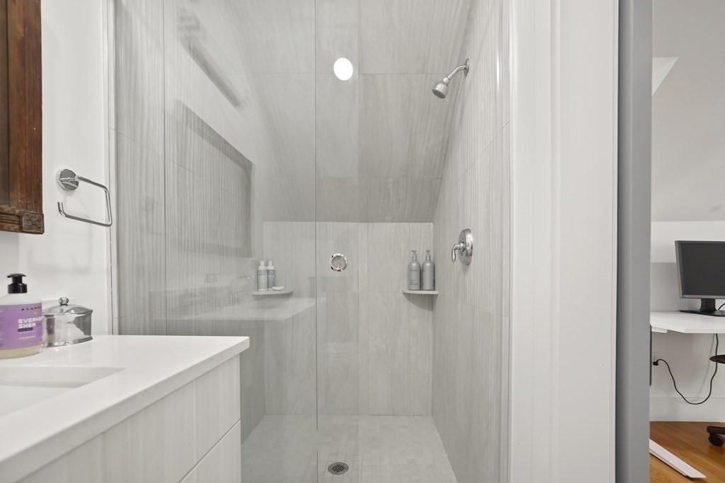 49 Boylston Street Boston, MA 02130 - Photo 26 of 36 a bathroom with a sink a toilet and shower