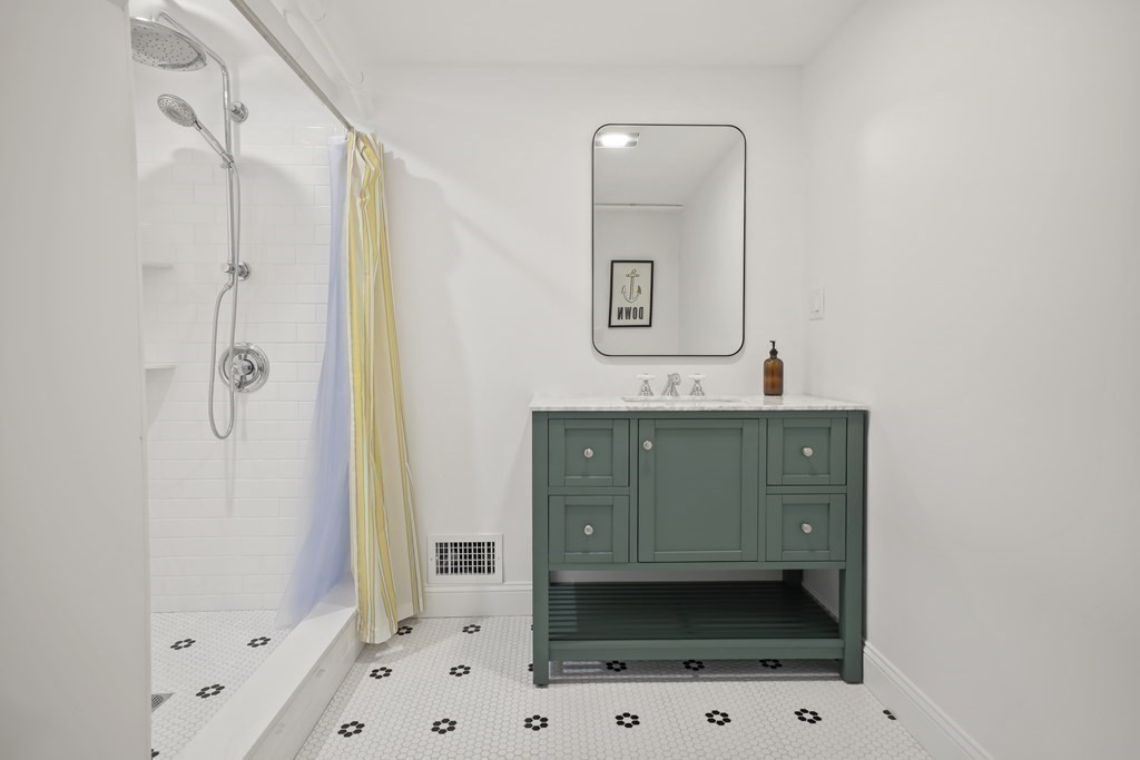 49 Boylston Street Boston, MA 02130 - Photo 30 of 36 a bathroom with a sink a mirror and a shower
