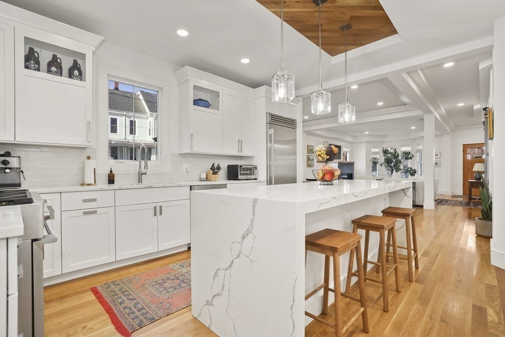 49 Boylston Street Boston, MA 02130 - Photo 5 of 36 a kitchen with stainless steel appliances kitchen island granite countertop a sink and cabinets