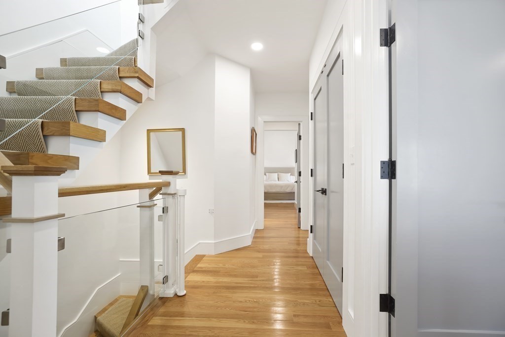 49 Boylston Street Boston, MA 02130 - Photo 10 of 36 a view of a hallway with wooden floor and staircase