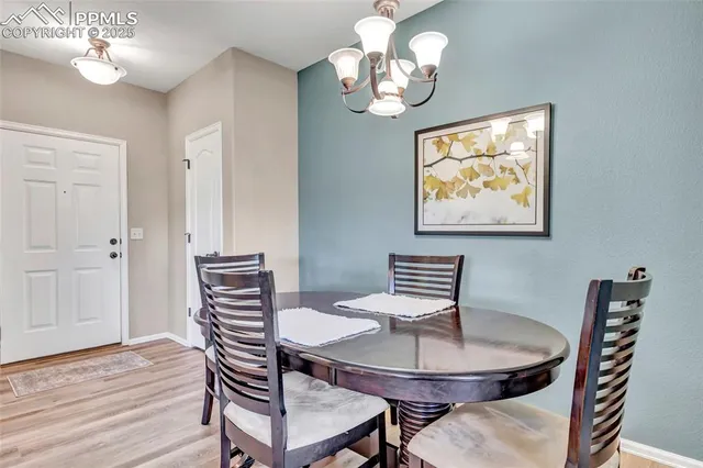 a view of a dining room with furniture wooden floor and a chandelier