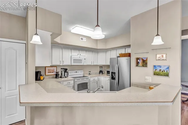 a kitchen with a refrigerator a stove a sink and a refrigerator