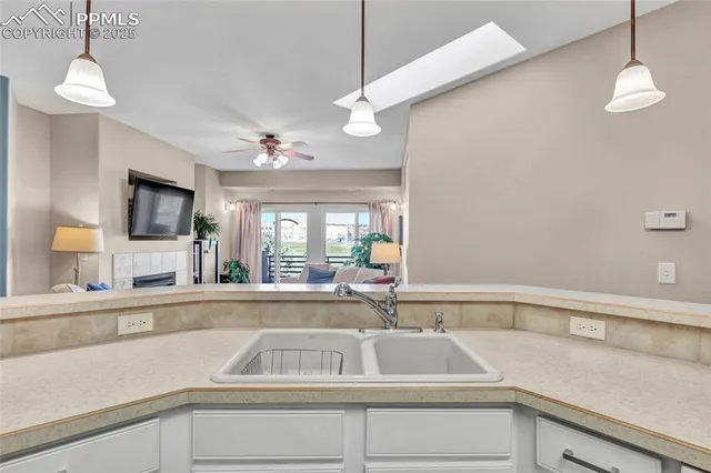 a kitchen that has a sink and a large window
