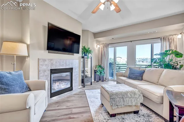 a living room with furniture a flat screen tv and a fireplace