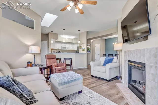 a living room with furniture a fireplace and a flat screen tv