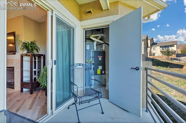 a view of a hallway and a livingroom with furniture