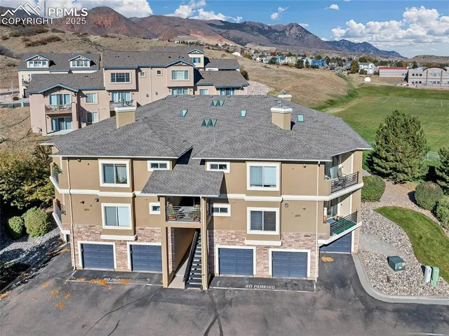 an aerial view of a house with a yard and sitting space