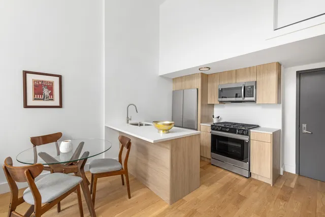 a view of a livingroom with furniture and a window