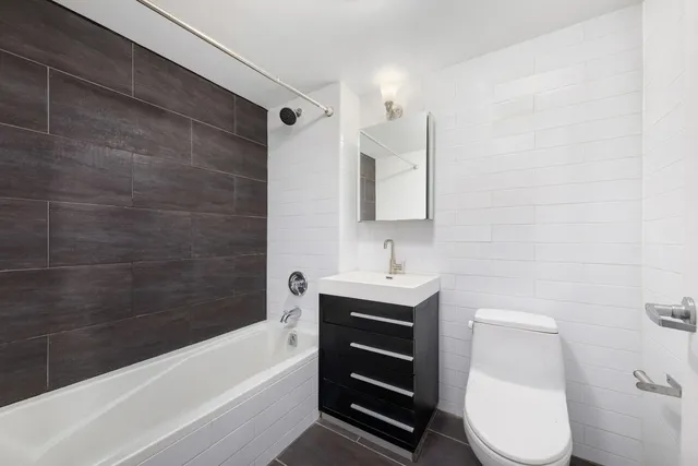 a hotel room with two beds and a chair